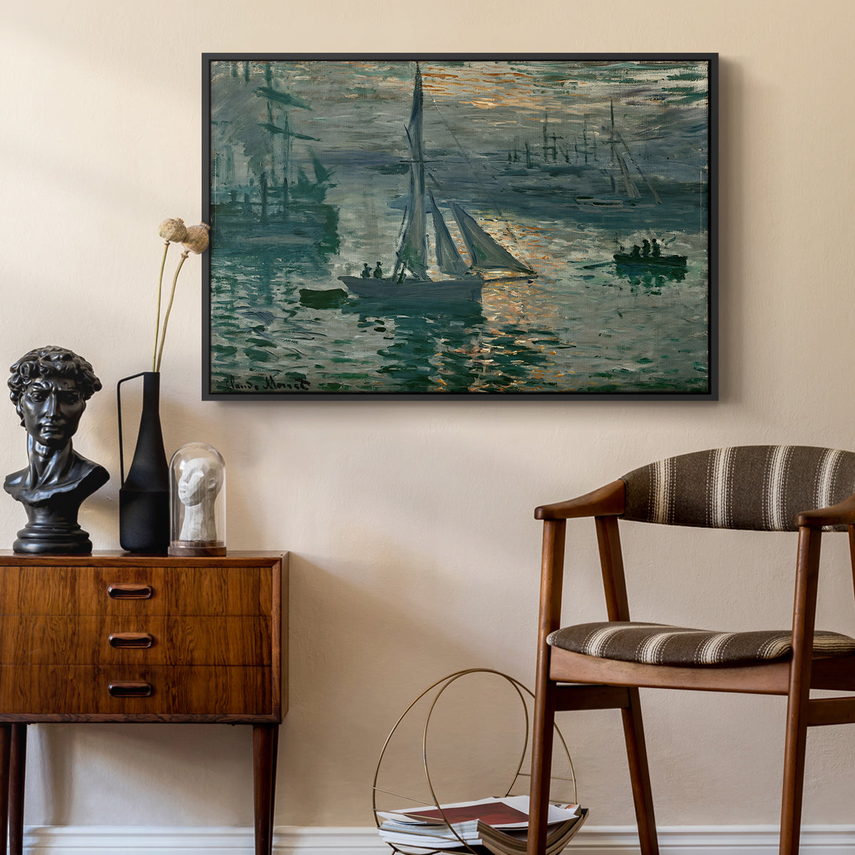 Sunrise (Marine), 1873 by Claude Monet as a black floater framed canvas featuring an early morning harbor scene with boats and diffused light, styled above a mid-century console in a contemporary living area.