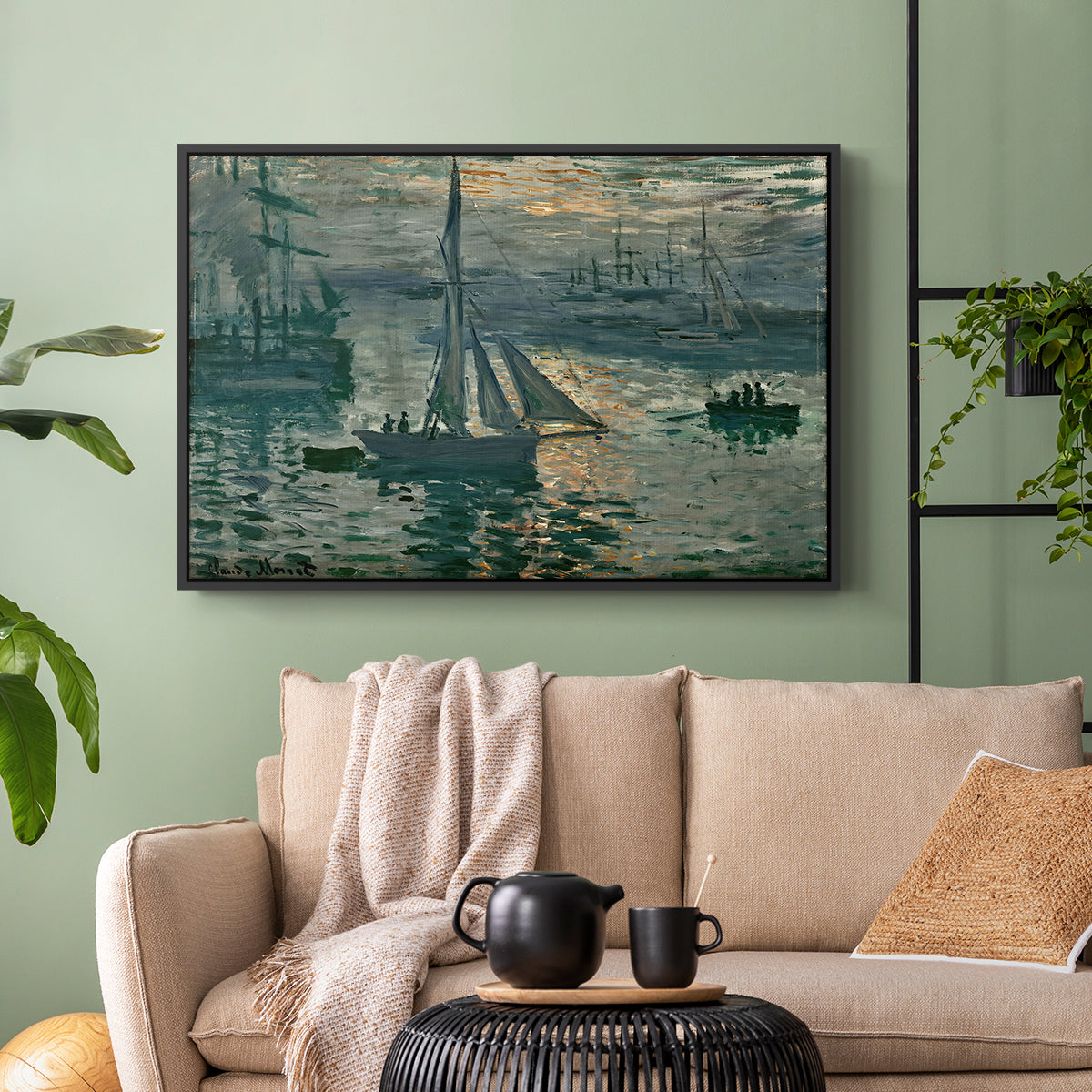 Black floater framed canvas featuring an atmospheric ocean view with sun rising through haze, displayed above a sofa in a modern living room.