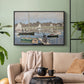 Black floater framed canvas featuring a tranquil river setting with sailboats and shoreline, displayed above a sofa in a modern living room.