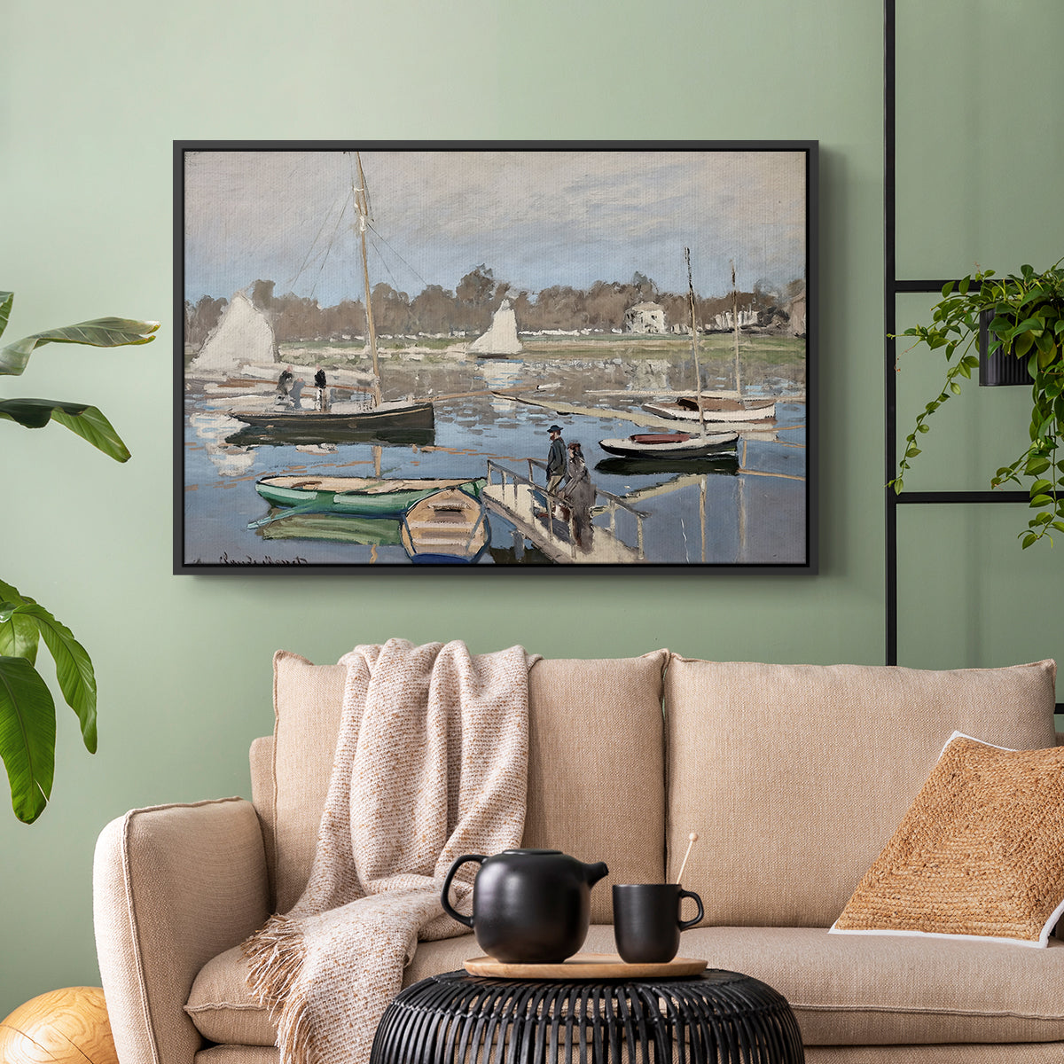 Black floater framed canvas featuring a tranquil river setting with sailboats and shoreline, displayed above a sofa in a modern living room.