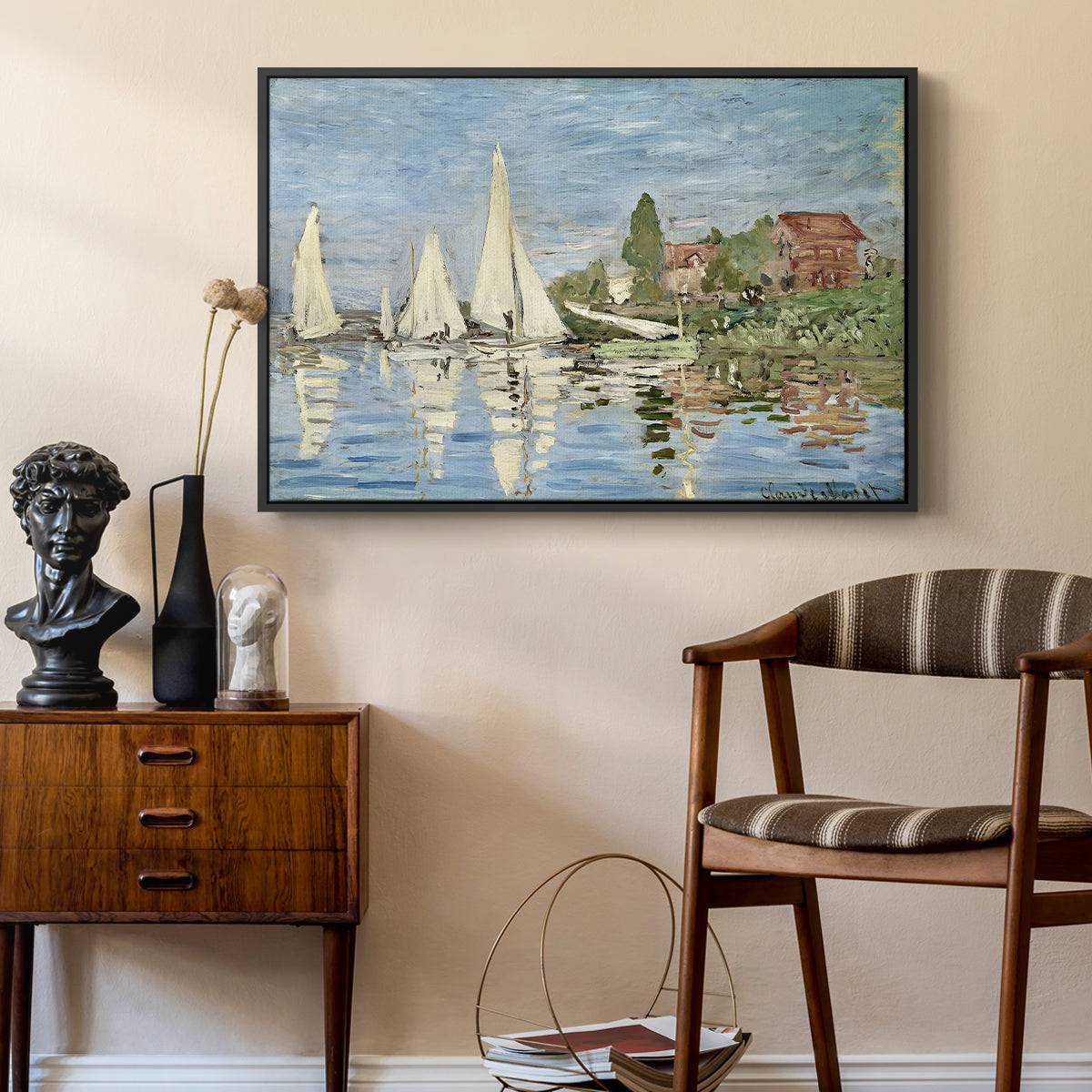 Regatta at Argenteuil, 1872 by Claude Monet as a black floater framed canvas featuring an impressionist depiction of sailing competition on water, styled above a mid-century console in a contemporary living area.