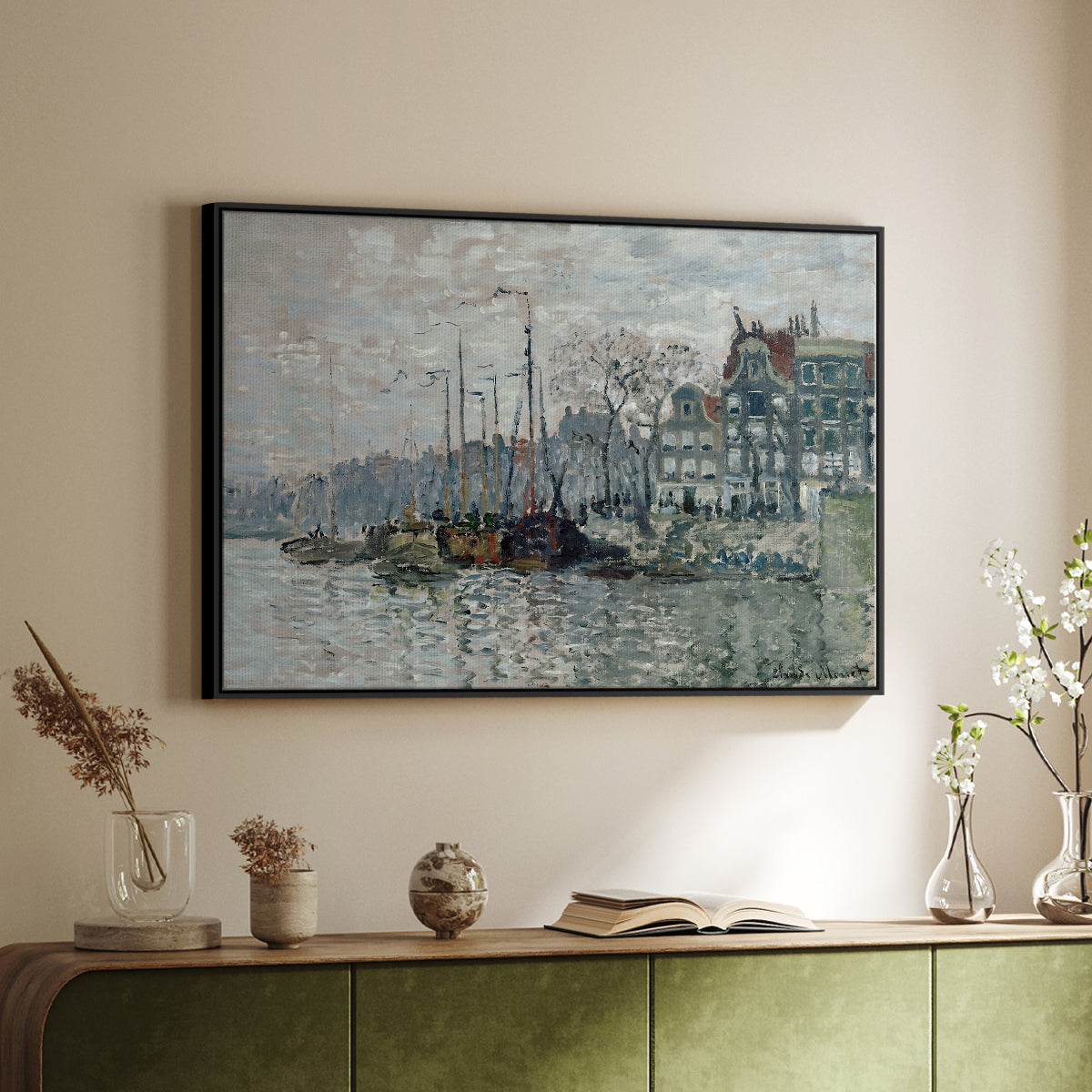 Black floater framed canvas of View of the Prins Hendrikkade and Kromme Waal in Amsterdam, 1874 by Claude Monet, featuring an impressionist cityscape of canal with ships and architecture above a sideboard in a softly lit hallway.