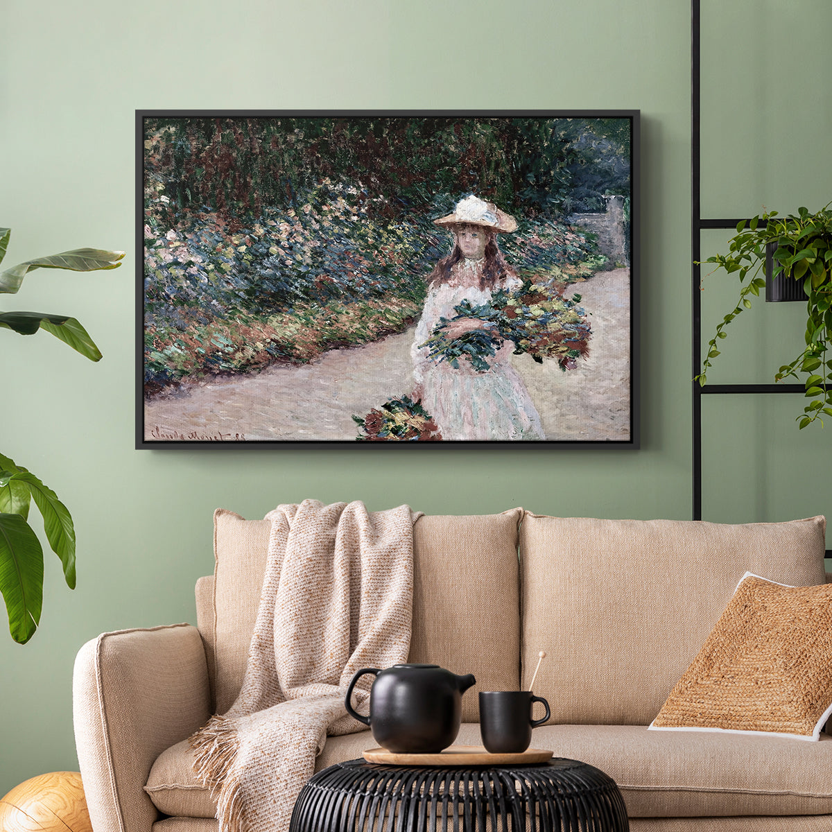 Black floater framed canvas featuring a tranquil outdoor portrait of girl in floral setting, displayed above a sofa in a modern living room.