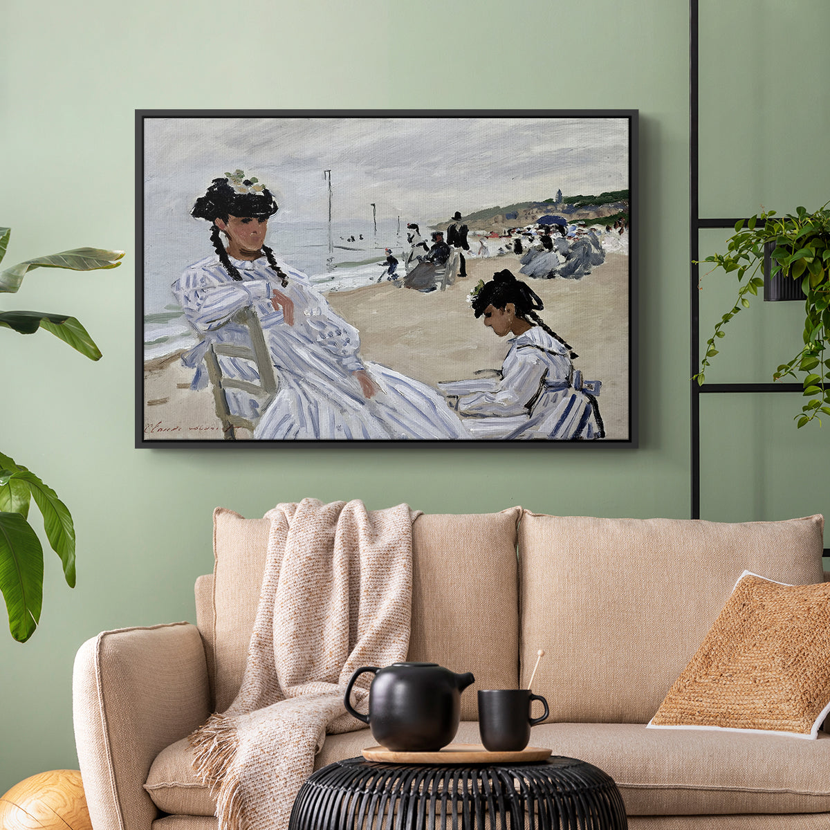 Black floater framed canvas featuring a coastal leisure scene with figures looking out to sea, displayed above a sofa in a modern living room.