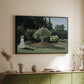 Black floater framed canvas of Woman in the Garden, Sainte-Adresse, 1867 by Claude Monet, featuring an impressionist figure in sunlit garden with lush vegetation above a sideboard in a softly lit hallway.