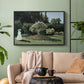 Black floater framed canvas featuring a tranquil garden portrait with soft natural light, displayed above a sofa in a modern living room.