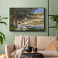Black floater framed canvas featuring a quiet outdoor setting with figures near river under foliage, displayed above a sofa in a modern living room.