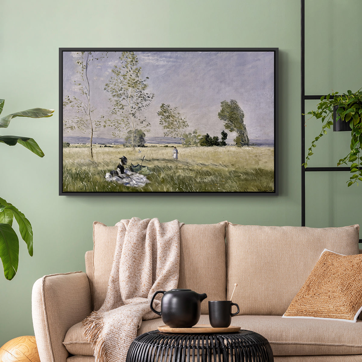 Black floater framed canvas featuring a tranquil summer landscape with lone figure in nature, displayed above a sofa in a modern living room.