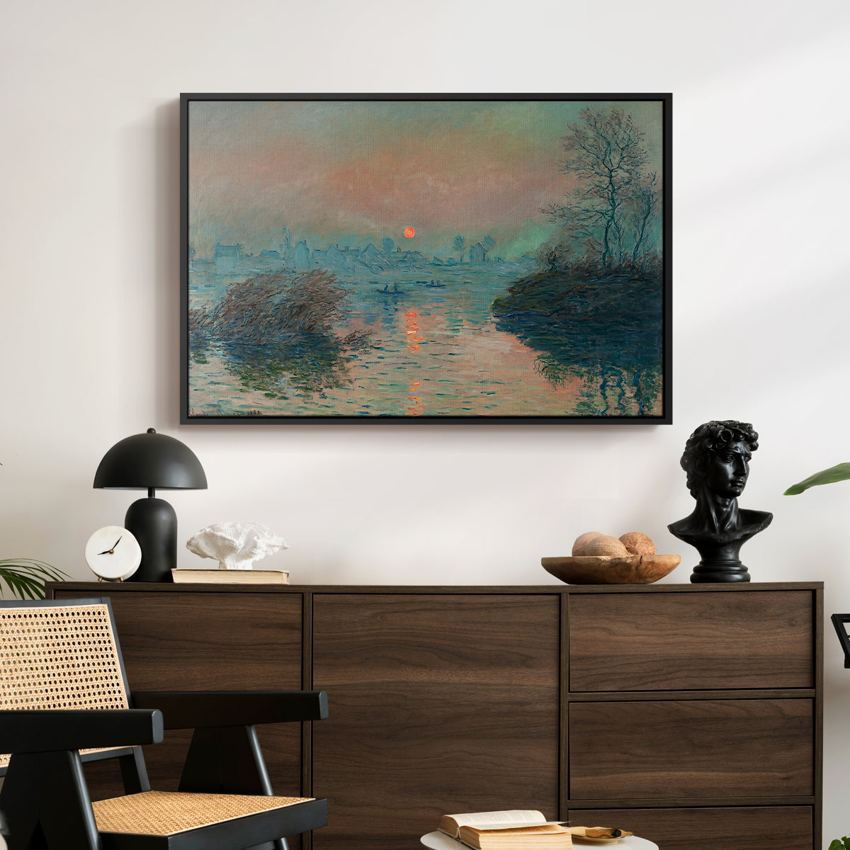 Sunset on the Seine at Lavacourt, Winter Effect, 1880 by Claude Monet displayed in a black floater framed canvas above a dark wood credenza in an entryway.