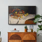 Still Life with Apples and Grapes, 1880 by Claude Monet in a black floater framed canvas featuring an arrangement of apples and grapes on table with soft natural light, displayed above a wood console cabinet.