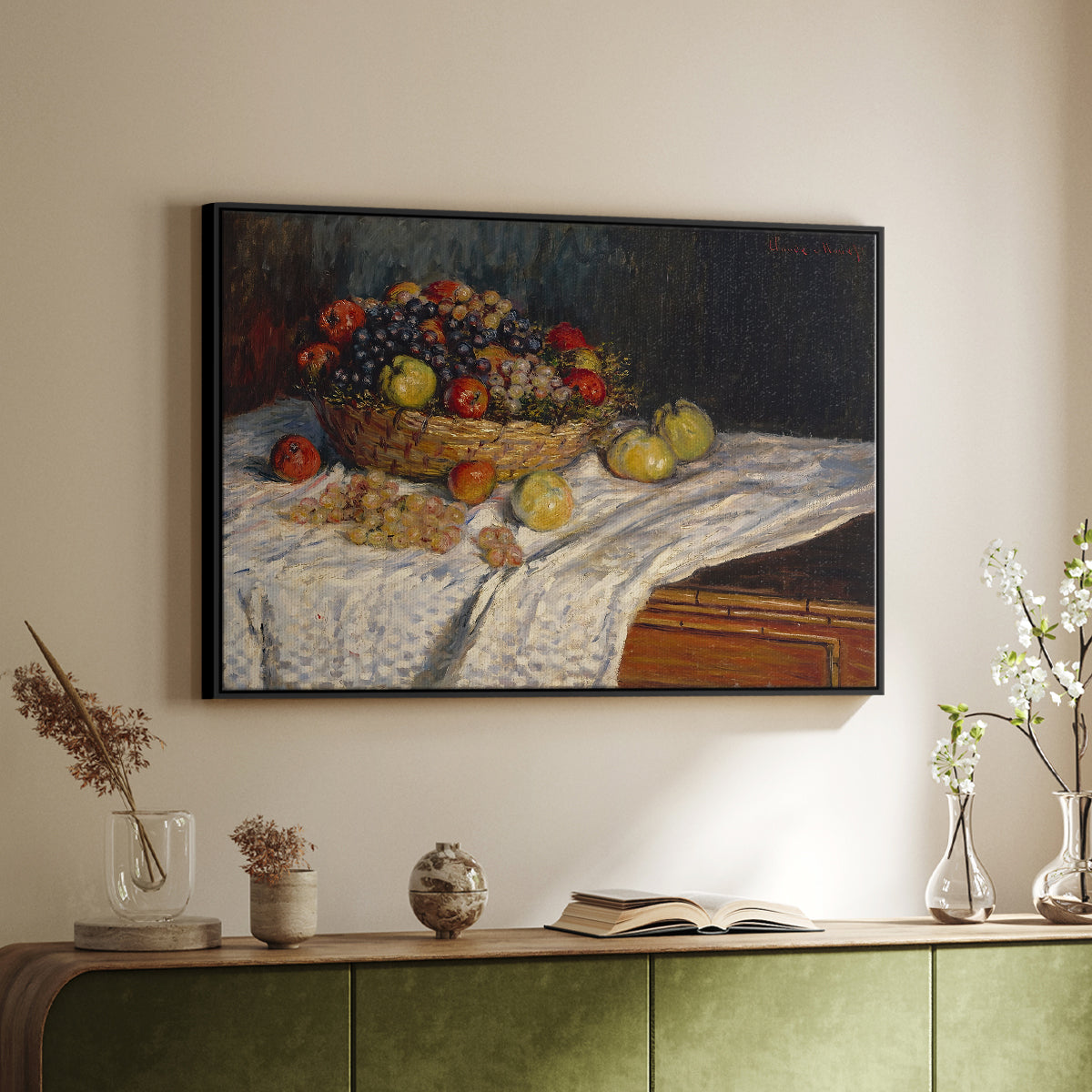 Black floater framed canvas of Still Life with Apples and Grapes, 1880 by Claude Monet, featuring an impressionist still life of fruit placed on cloth-covered surface above a sideboard in a softly lit hallway.