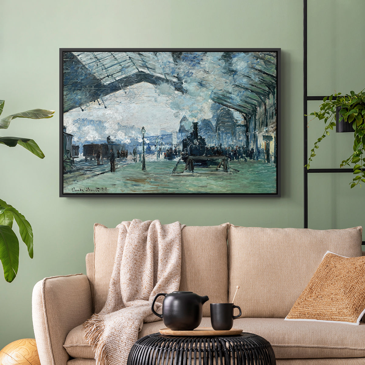 Black floater framed canvas featuring a dramatic depiction of industrial space with trains and light, displayed above a sofa in a modern living room.
