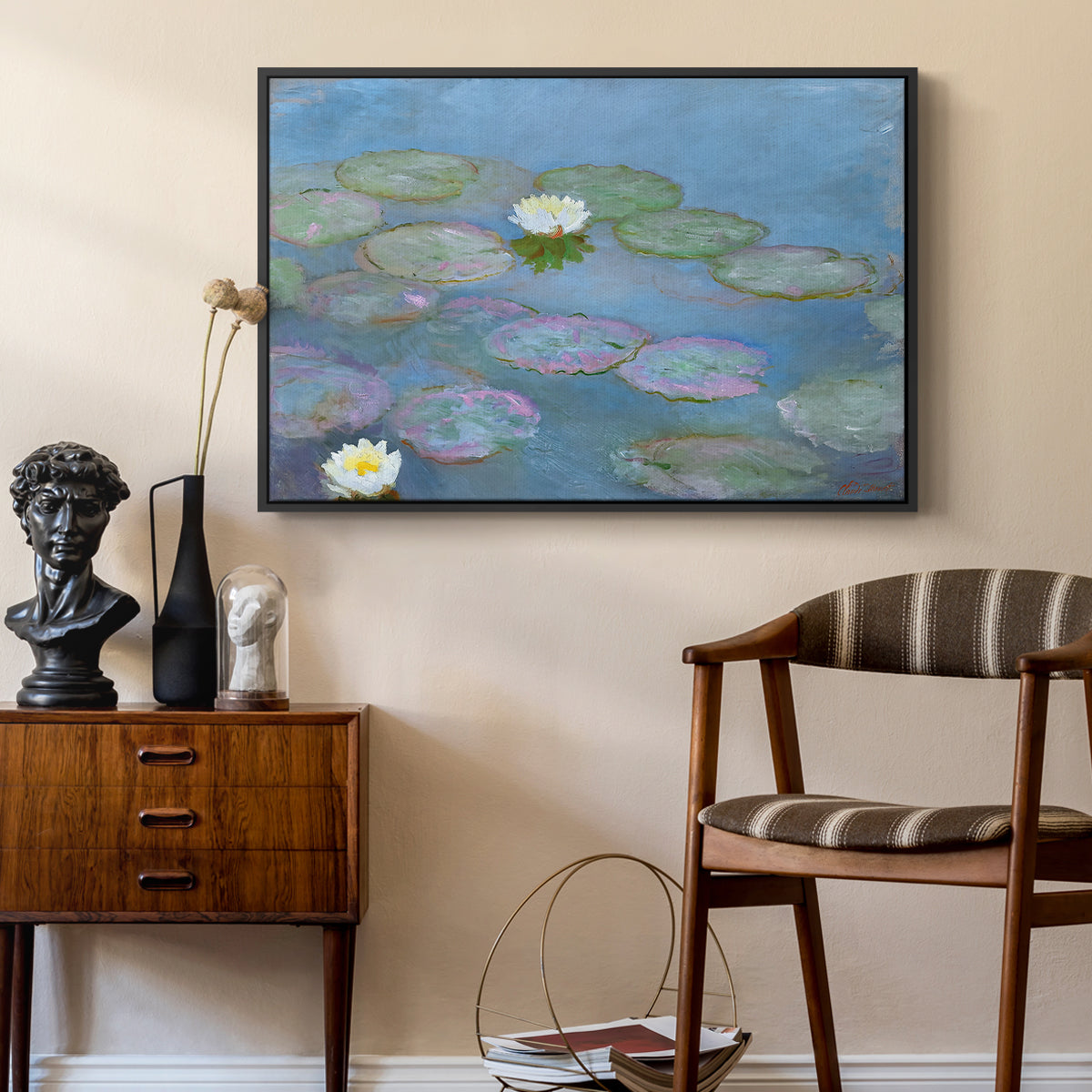 Water Lilies (Nymphéas), 1897-1899 by Claude Monet as a black floater framed canvas featuring a tranquil water surface covered with blooming lilies, styled above a mid-century console in a contemporary living area.