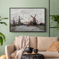 Black floater framed canvas featuring a landscape featuring windmills and low horizon sky, displayed above a sofa in a modern living room.