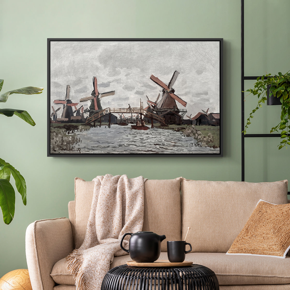 Black floater framed canvas featuring a landscape featuring windmills and low horizon sky, displayed above a sofa in a modern living room.