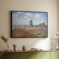 Black floater framed canvas of Tulip Fields with the Rijnsburg Windmill, 1886 by Claude Monet, featuring a vibrant agricultural landscape with flowers and windmill above a sideboard in a softly lit hallway.