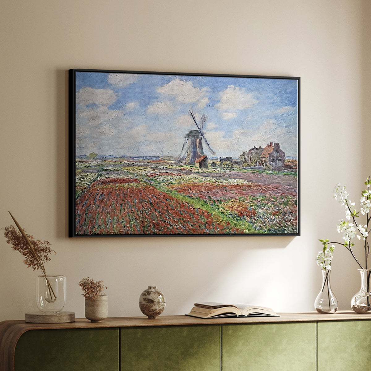 Black floater framed canvas of Tulip Fields with the Rijnsburg Windmill, 1886 by Claude Monet, featuring a vibrant agricultural landscape with flowers and windmill above a sideboard in a softly lit hallway.