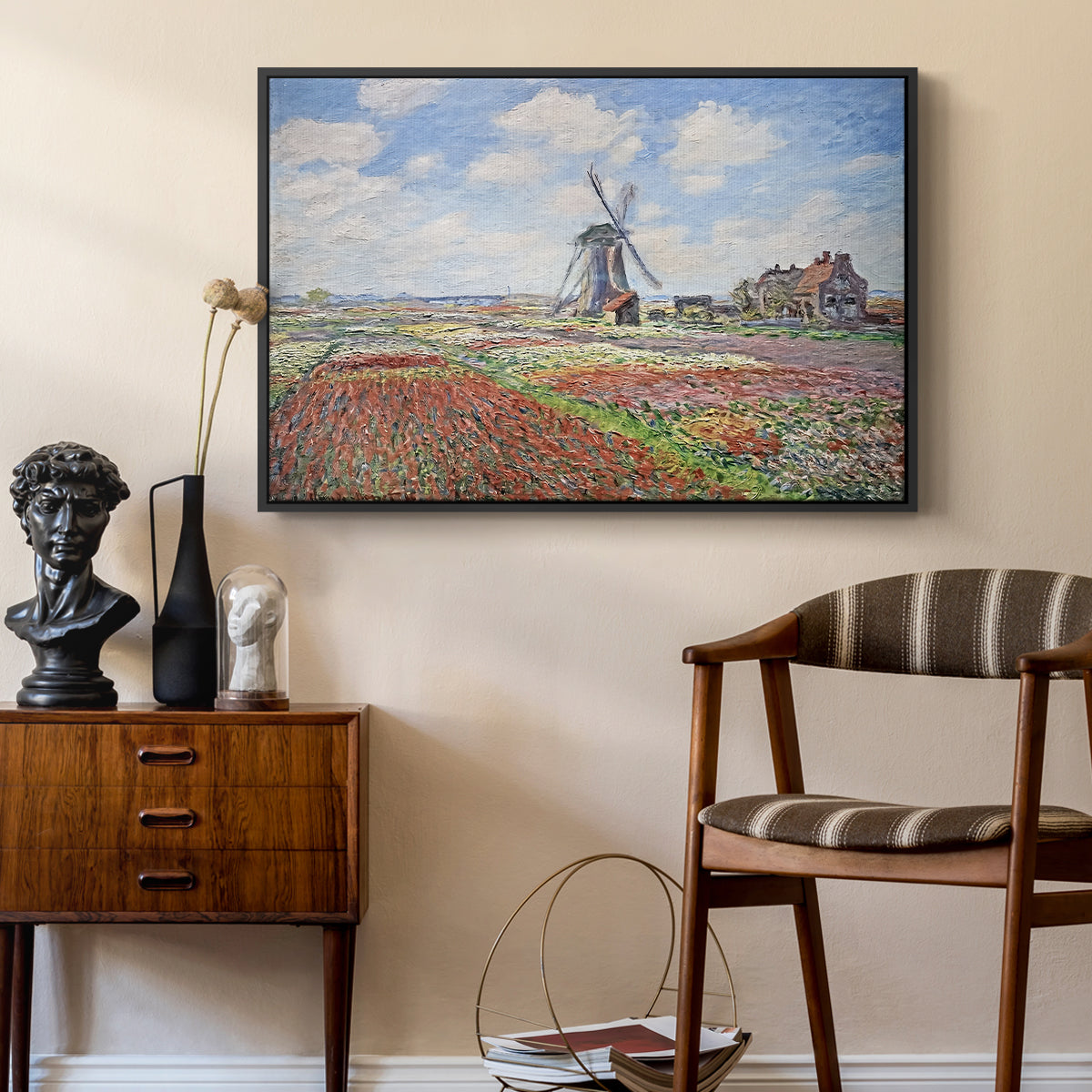 Tulip Fields with the Rijnsburg Windmill, 1886 by Claude Monet as a black floater framed canvas featuring an impressionist field of blooming tulips under bright sky, styled above a mid-century console in a contemporary living area.