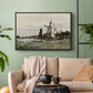 Black floater framed canvas featuring a countryside structure standing against open sky, displayed above a sofa in a modern living room.