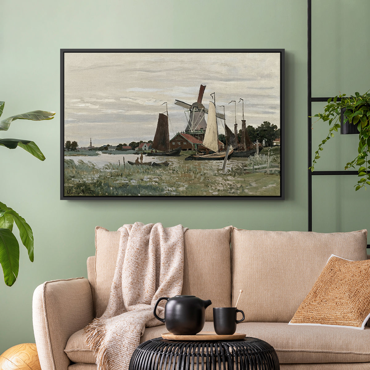 Black floater framed canvas featuring a countryside structure standing against open sky, displayed above a sofa in a modern living room.