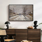 The Boulevard de Pontoise at Argenteuil, Snow Effect, 1875 by Claude Monet displayed in a black floater framed canvas above a dark wood credenza in an entryway.