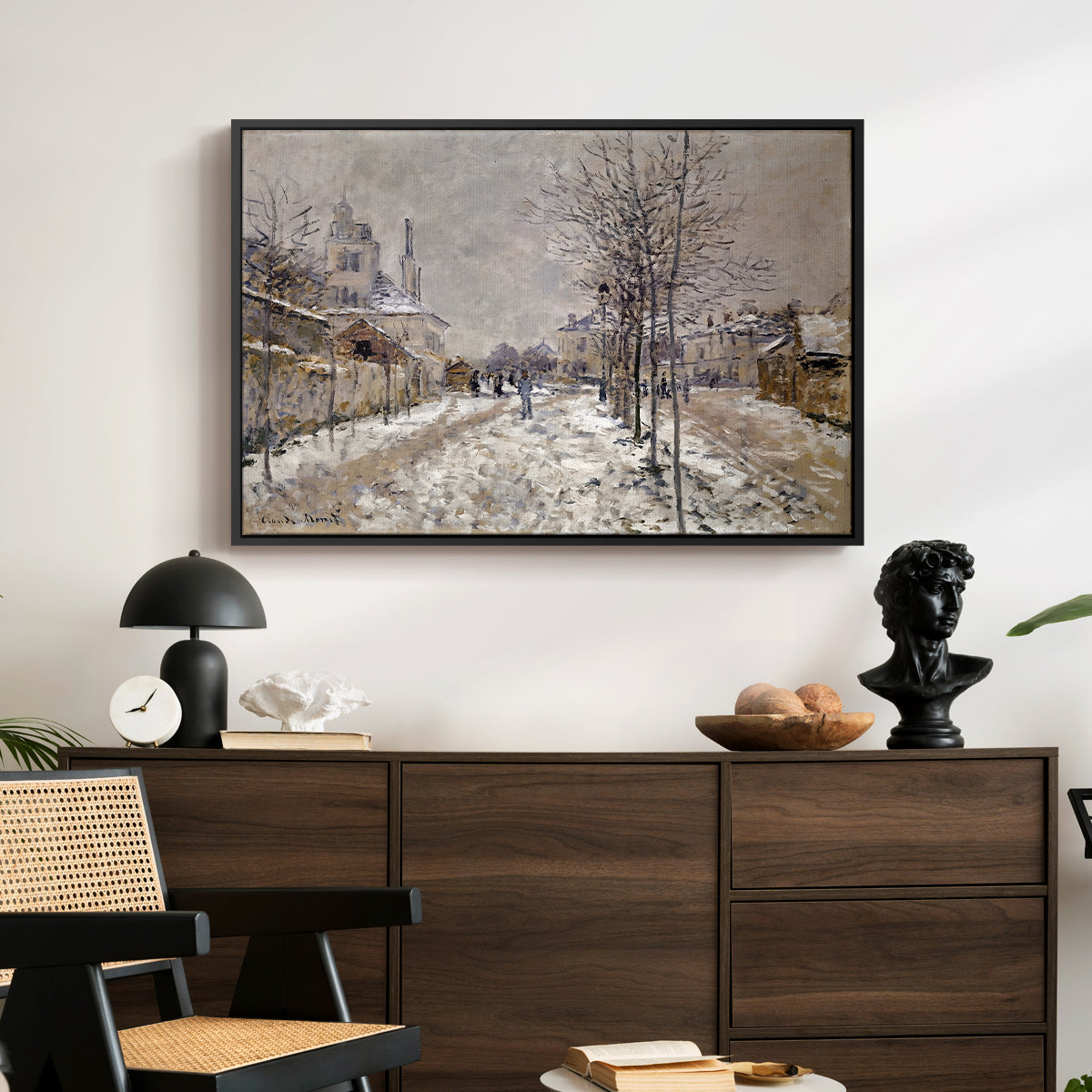 The Boulevard de Pontoise at Argenteuil, Snow Effect, 1875 by Claude Monet displayed in a black floater framed canvas above a dark wood credenza in an entryway.
