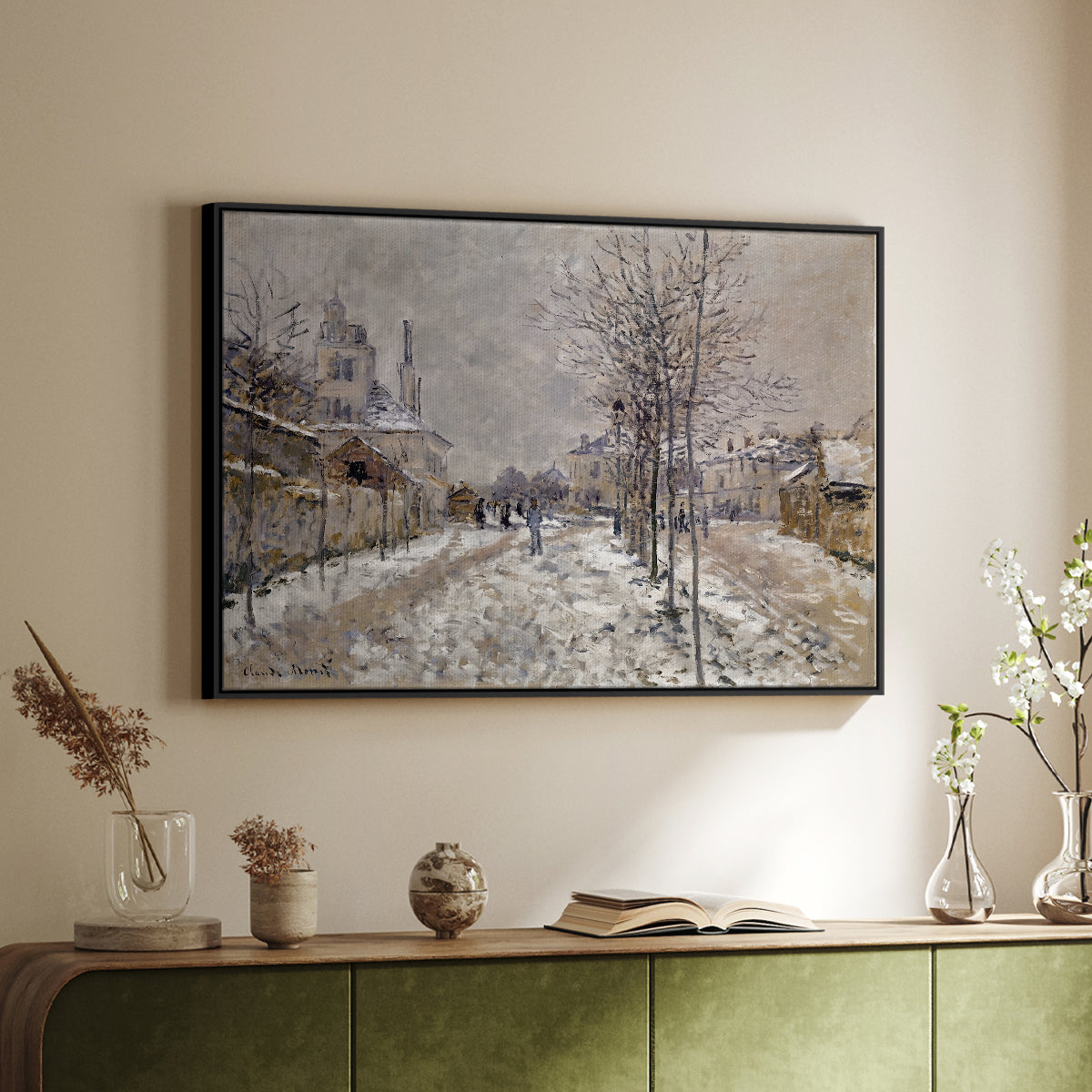 Black floater framed canvas of The Boulevard de Pontoise at Argenteuil, Snow Effect, 1875 by Claude Monet, featuring an impressionist winter scene with road and bare trees above a sideboard in a softly lit hallway.