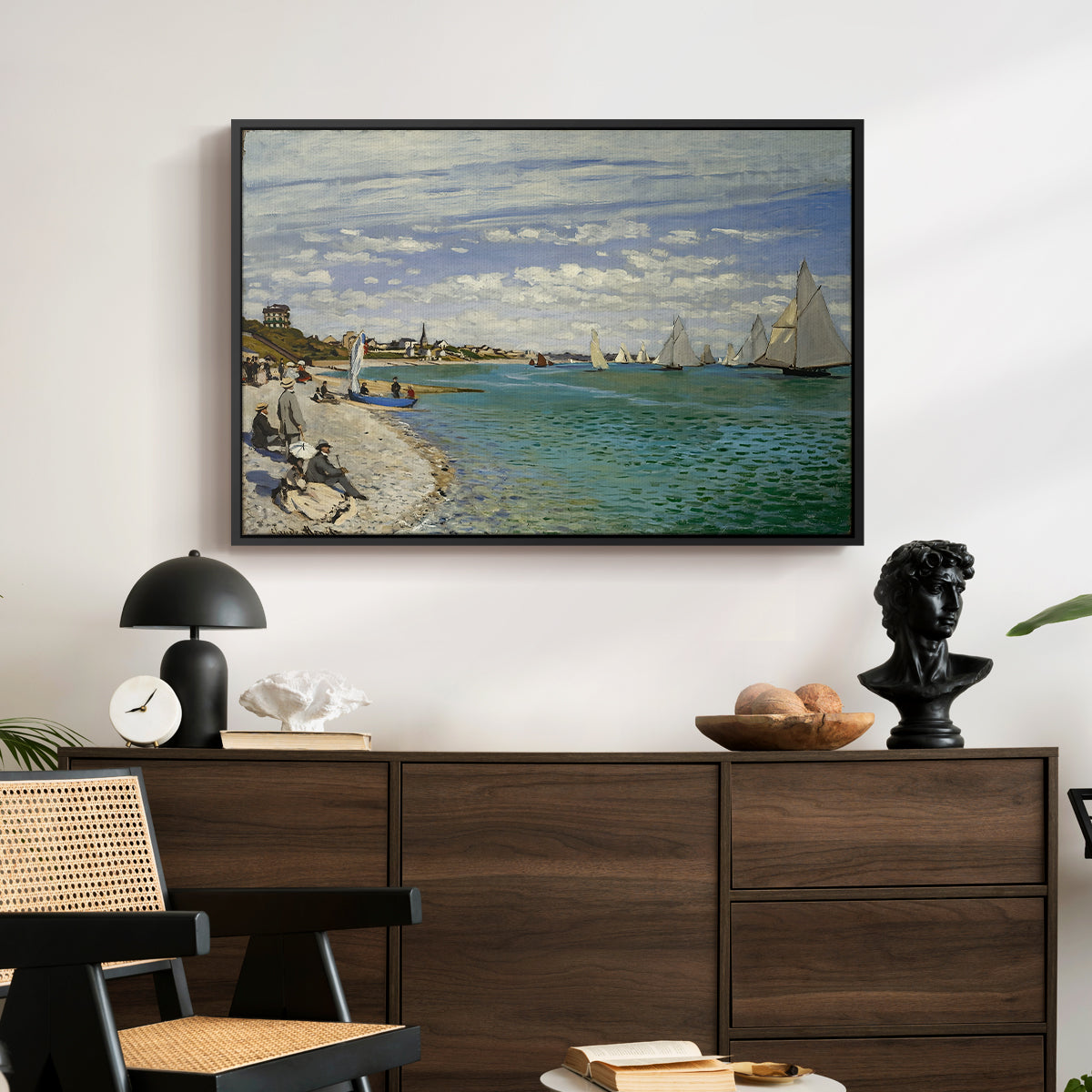 Regatta at Sainte-Adresse, 1867 by Claude Monet displayed in a black floater framed canvas above a dark wood credenza in an entryway.