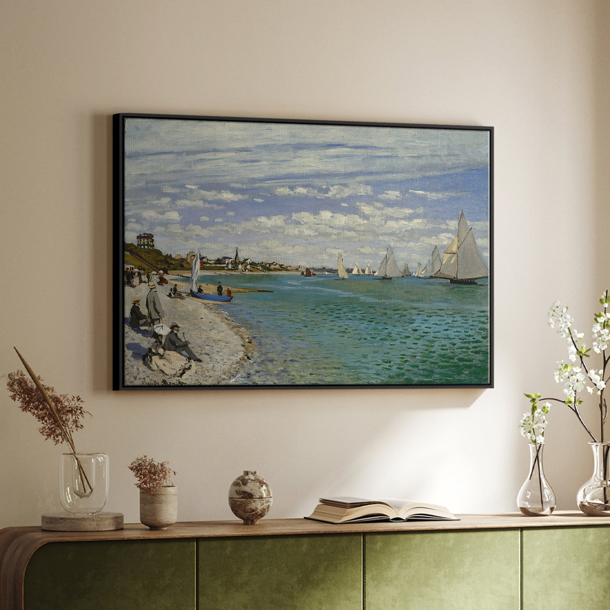 Black floater framed canvas of Regatta at Sainte-Adresse, 1867 by Claude Monet, featuring a lively regatta scene with boats and people on beach above a sideboard in a softly lit hallway.