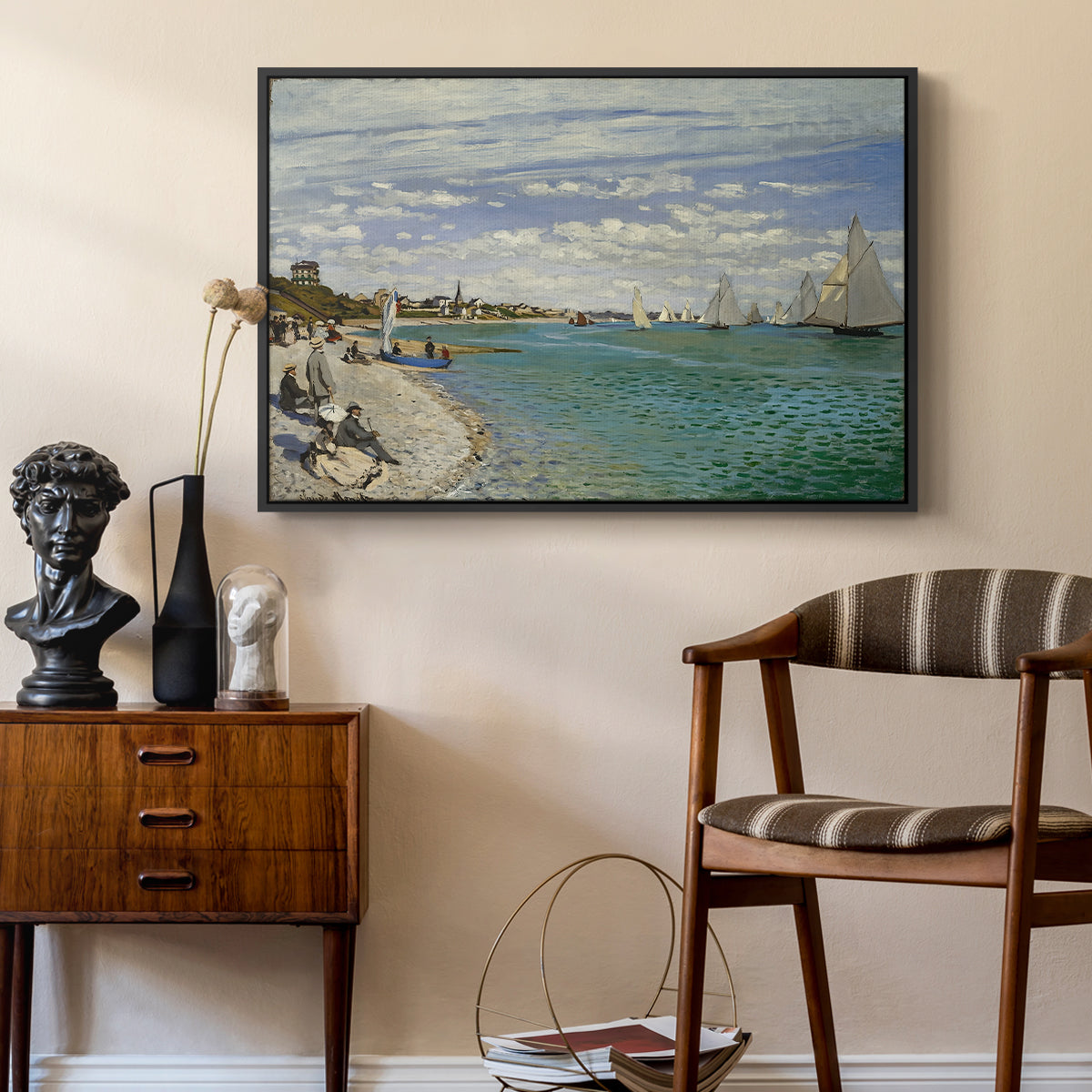 Regatta at Sainte-Adresse, 1867 by Claude Monet as a black floater framed canvas featuring an impressionist coastal view with colorful sails and shoreline activity, styled above a mid-century console in a contemporary living area.