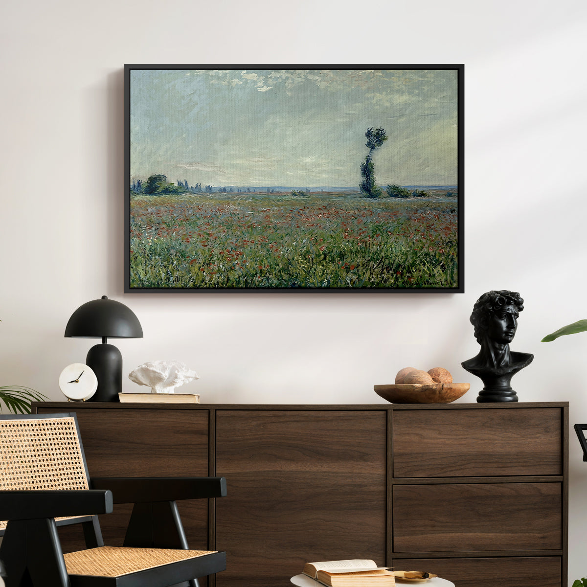 Poppy Field, 1881 by Claude Monet displayed in a black floater framed canvas above a dark wood credenza in an entryway.