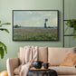 Black floater framed canvas featuring a natural field scene with vibrant red flowers, displayed above a sofa in a modern living room.