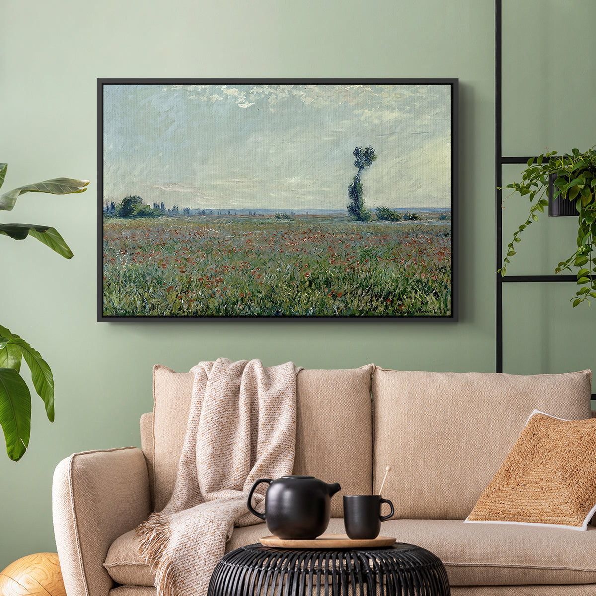 Black floater framed canvas featuring a natural field scene with vibrant red flowers, displayed above a sofa in a modern living room.