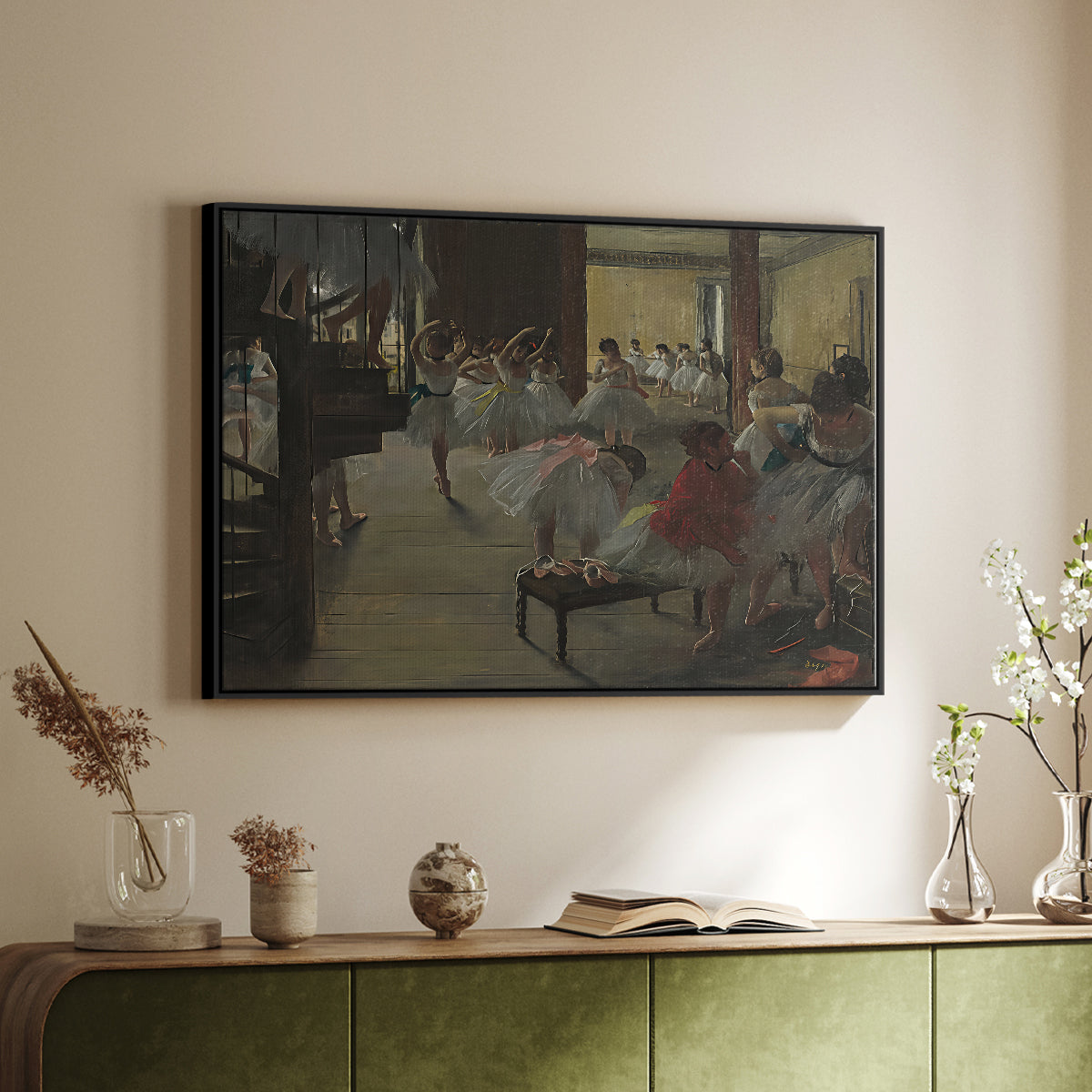 Black floater framed canvas of The Dance Class, c. 1873 by Edgar Degas, featuring a rehearsal scene with dancers stretching and posing indoors above a sideboard in a softly lit hallway.