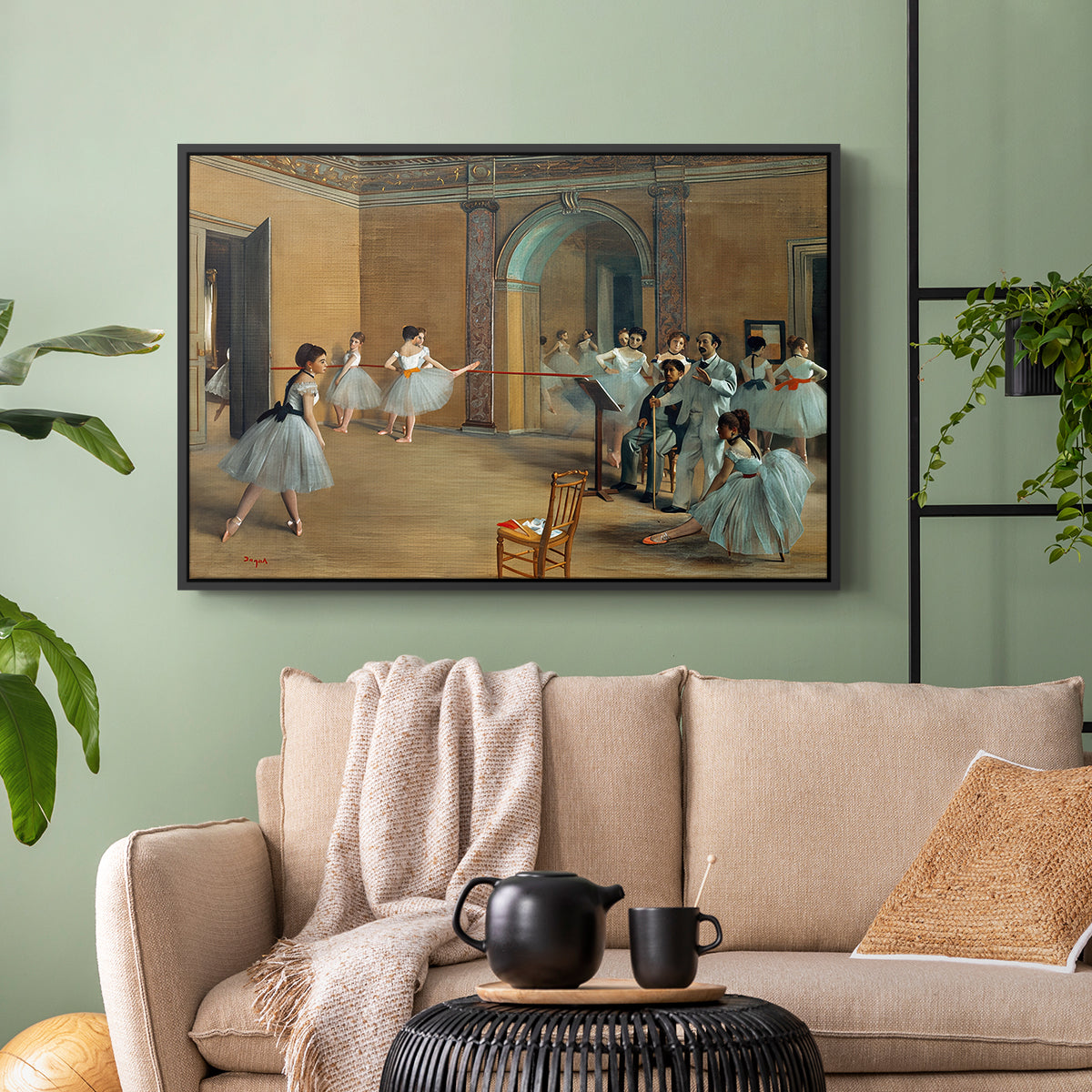 Black floater framed canvas featuring an elegant rehearsal space with dancers in soft lighting, displayed above a sofa in a modern living room.