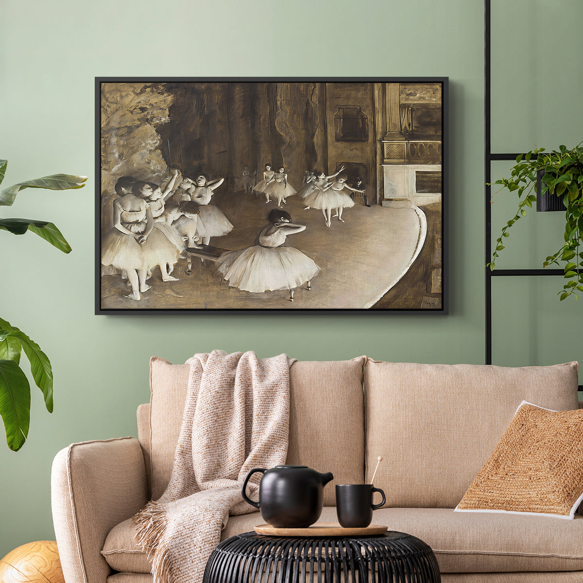 Black floater framed canvas featuring dancers arranged on stage with visible set and depth, displayed above a sofa in a modern living room.
