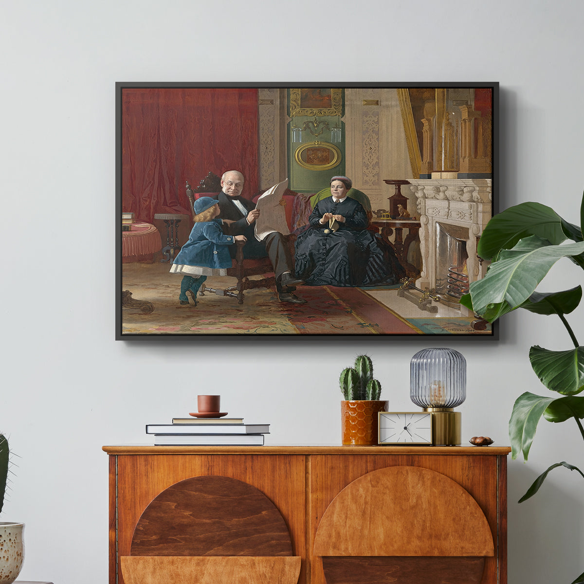 The Brown Family, 1869 by Eastman Johnson in a black floater framed canvas featuring a family seated together in interior room engaged in quiet activity, displayed above a wood console cabinet.