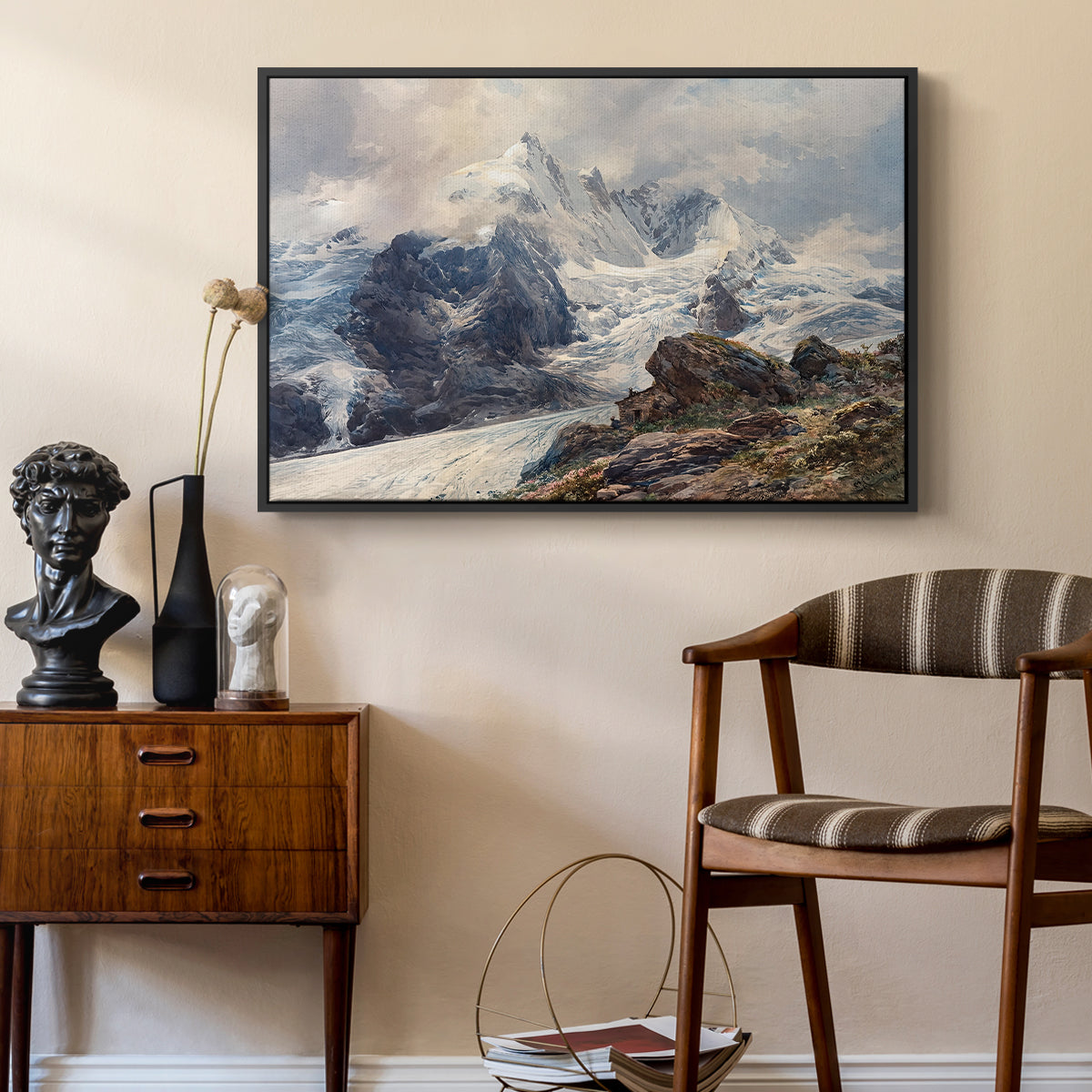 The Grossglockner, 1880 by Edward Theodore Compton as a black floater framed canvas featuring a realistic landscape of high mountain under open sky, styled above a mid-century console in a contemporary living area.