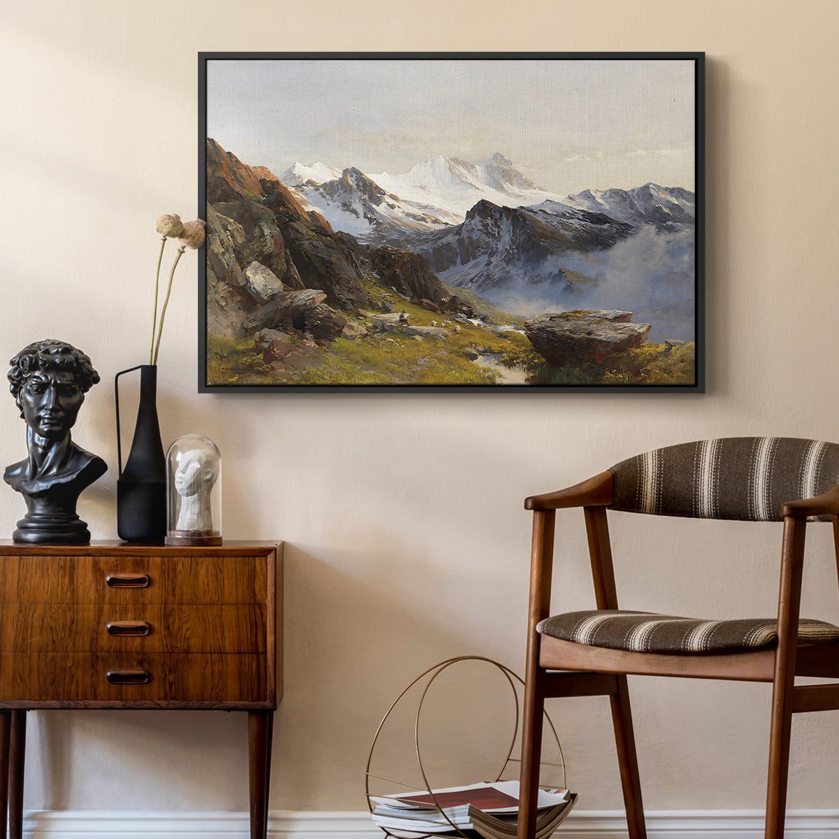 The Großglockner from the Prager Hut, 1890 by Edward Theodore Compton as a black floater framed canvas featuring an alpine vista with towering peak and foreground terrain, styled above a mid-century console in a contemporary living area.