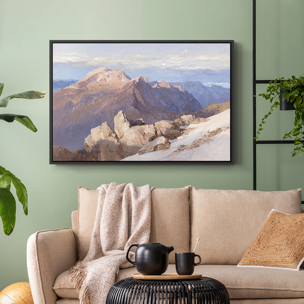 Black floater framed canvas featuring an expansive mountainous landscape with natural depth, displayed above a sofa in a modern living room.