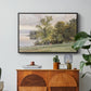 Landscape at Lake Starnberg, 1890 by Edward Theodore Compton in a black floater framed canvas featuring a lakeside landscape with calm water and trees along shoreline, displayed above a wood console cabinet.