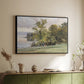 Black floater framed canvas of Landscape at Lake Starnberg, 1890 by Edward Theodore Compton, featuring a peaceful lake scene with reflections and surrounding greenery above a sideboard in a softly lit hallway.