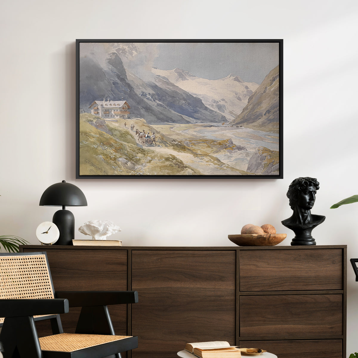 Shepherds (Pasterze), c. 1921 by Edward Theodore Compton displayed in a black floater framed canvas above a dark wood credenza in an entryway.