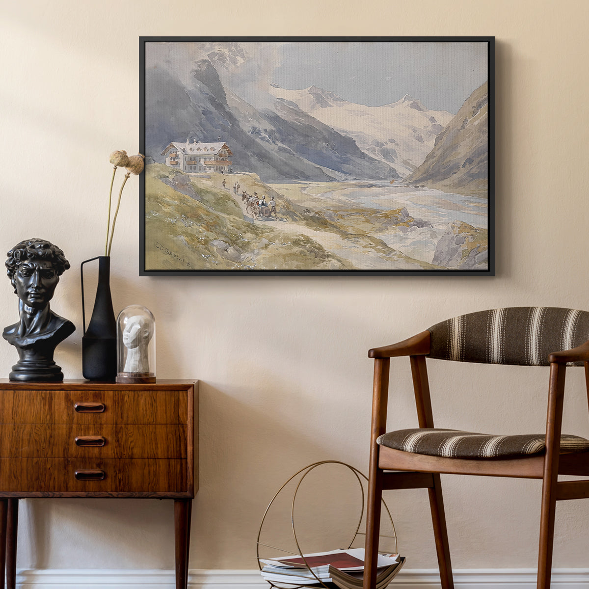 Shepherds (Pasterze), c. 1921 by Edward Theodore Compton as a black floater framed canvas featuring a rural alpine setting with shepherds and open terrain, styled above a mid-century console in a contemporary living area.
