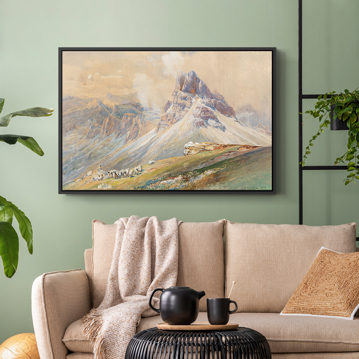 Black floater framed canvas featuring a realistic mountain view with strong geological forms, displayed above a sofa in a modern living room.