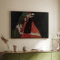 Black floater framed canvas of Cardinal and Nun (Caress), 1912 by Egon Schiele, featuring a cardinal and nun depicted in close emotional interaction above a sideboard in a softly lit hallway.