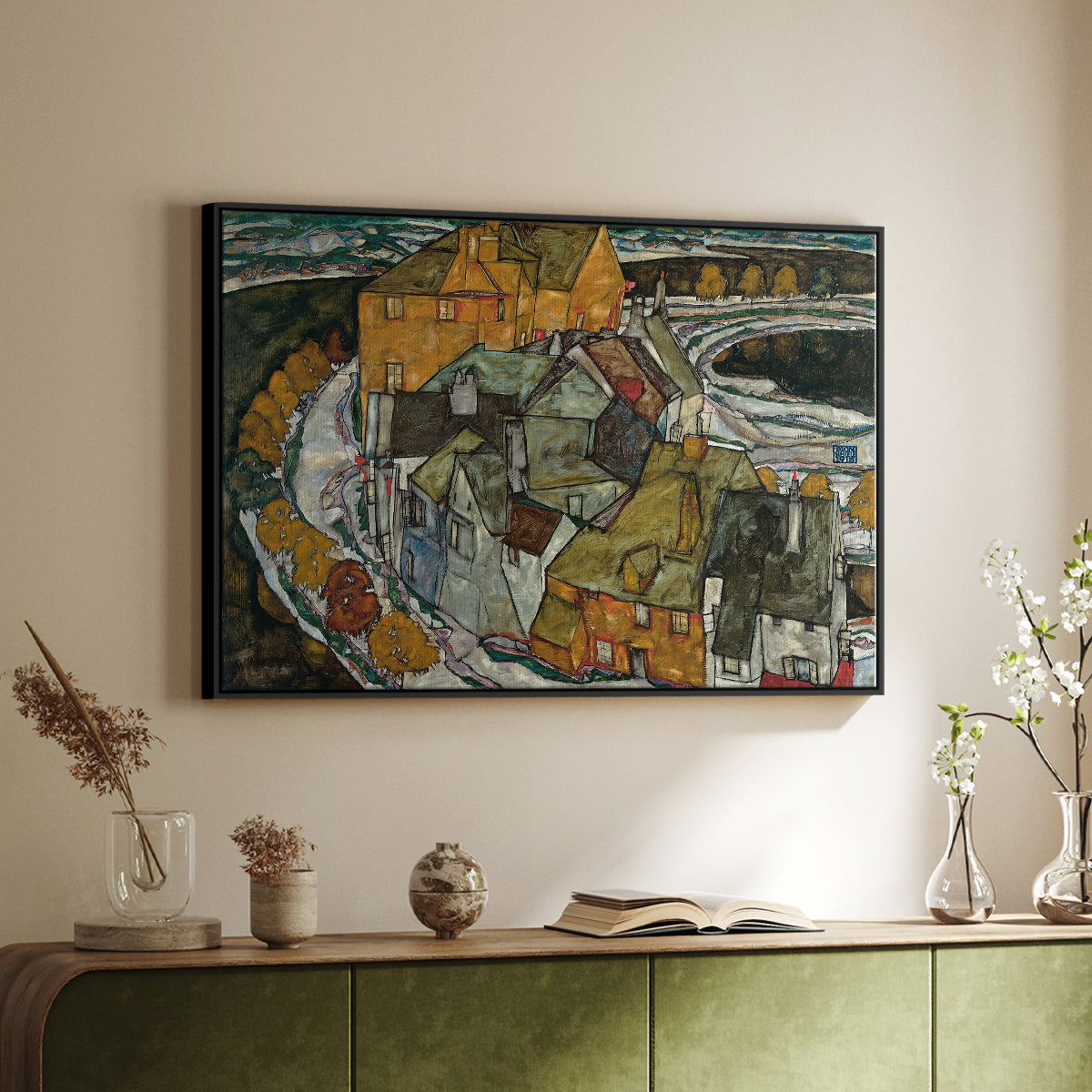 Black floater framed canvas of Crescent of Houses II (Island Town), 1915 by Egon Schiele, featuring a stylized townscape with clustered buildings and bold outlines above a sideboard in a softly lit hallway.