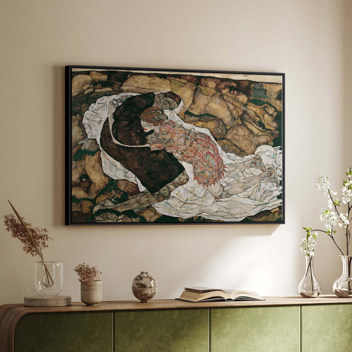Black floater framed canvas of Death and the Maiden, 1915 by Egon Schiele, featuring a symbolic scene of mortality with two figures clinging together above a sideboard in a softly lit hallway.