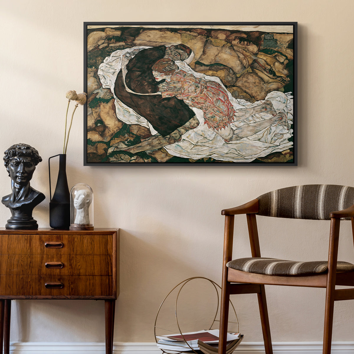 Death and the Maiden, 1915 by Egon Schiele as a black floater framed canvas featuring an expressionist painting of human figures in dramatic pose, styled above a mid-century console in a contemporary living area.