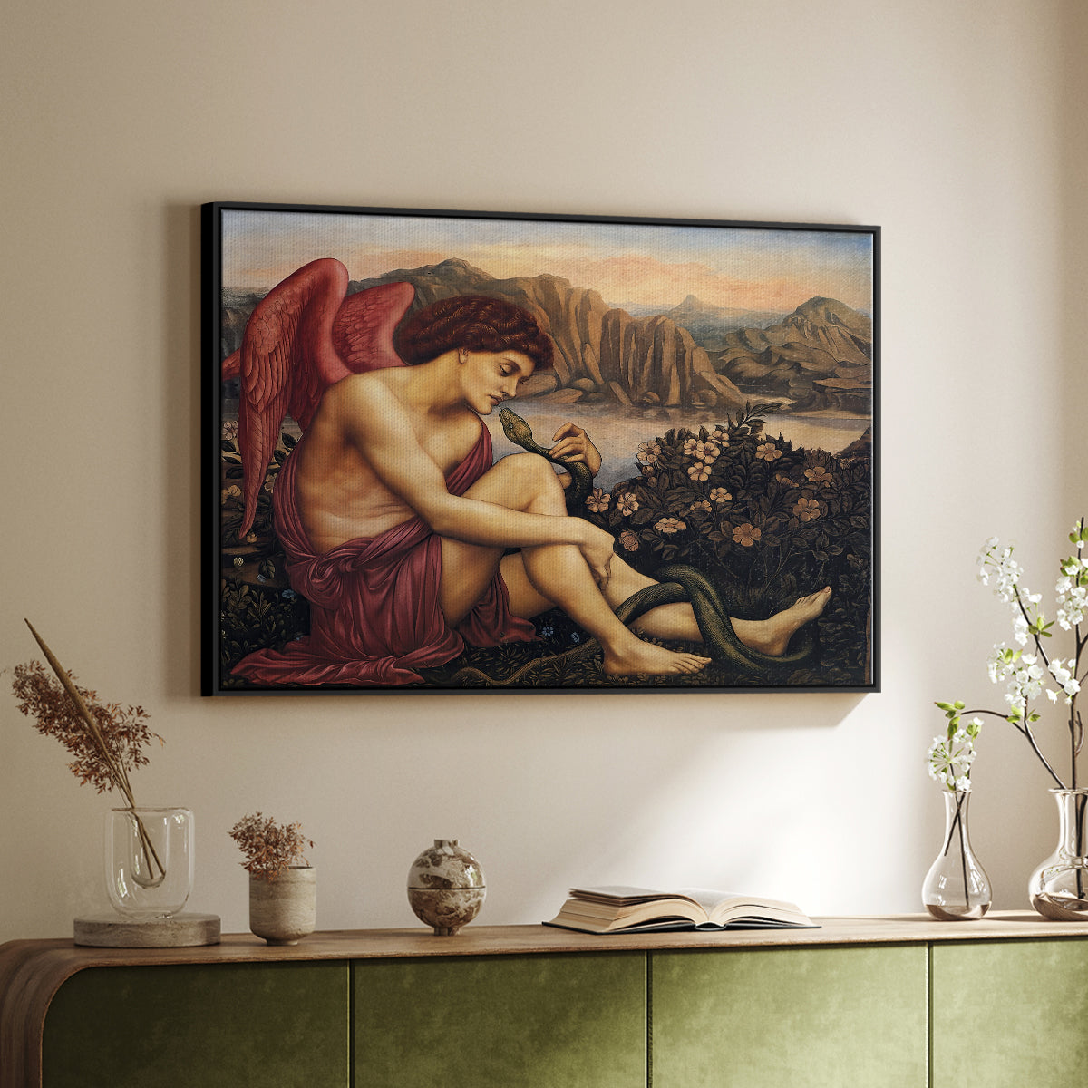 Black floater framed canvas of The Angel with the Serpent, c. 1870-1875 by Evelyn De Morgan, featuring a winged figure standing over serpent in allegorical composition above a sideboard in a softly lit hallway.